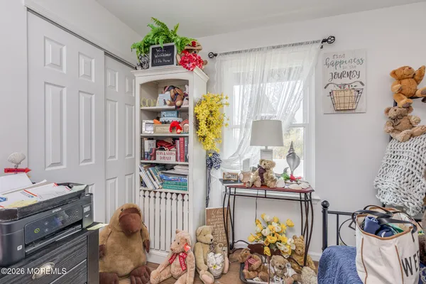 a bedroom with a bed and a flat tv screen on the dresser