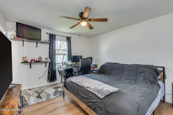 a bedroom with a bed and a chandelier