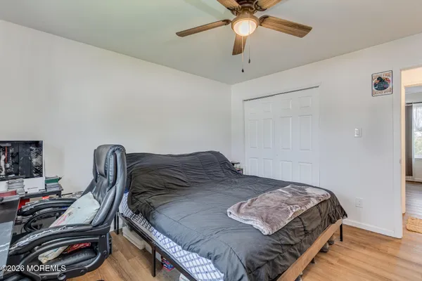 a living room with furniture flat screen tv and a wall painting
