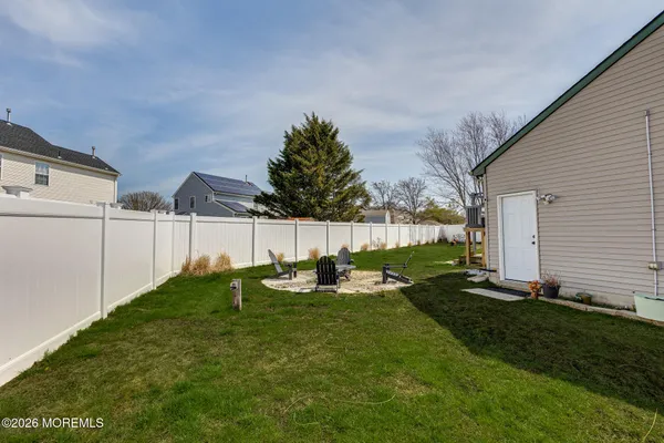 a backyard of a house with table and chairs