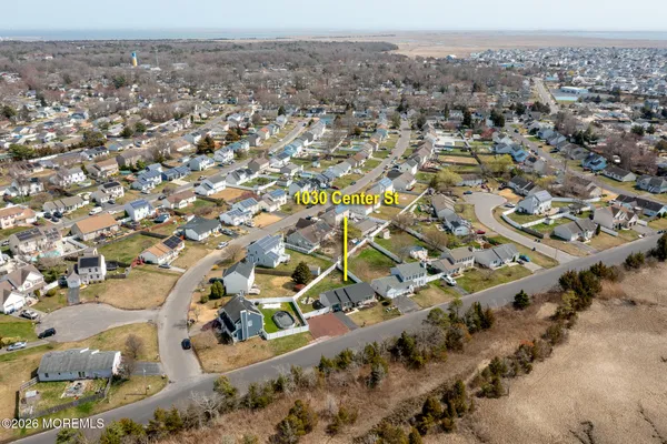 an aerial view of residential houses with city view