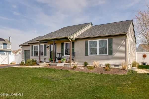 a front view of house with outdoor seating yard and barbeque oven