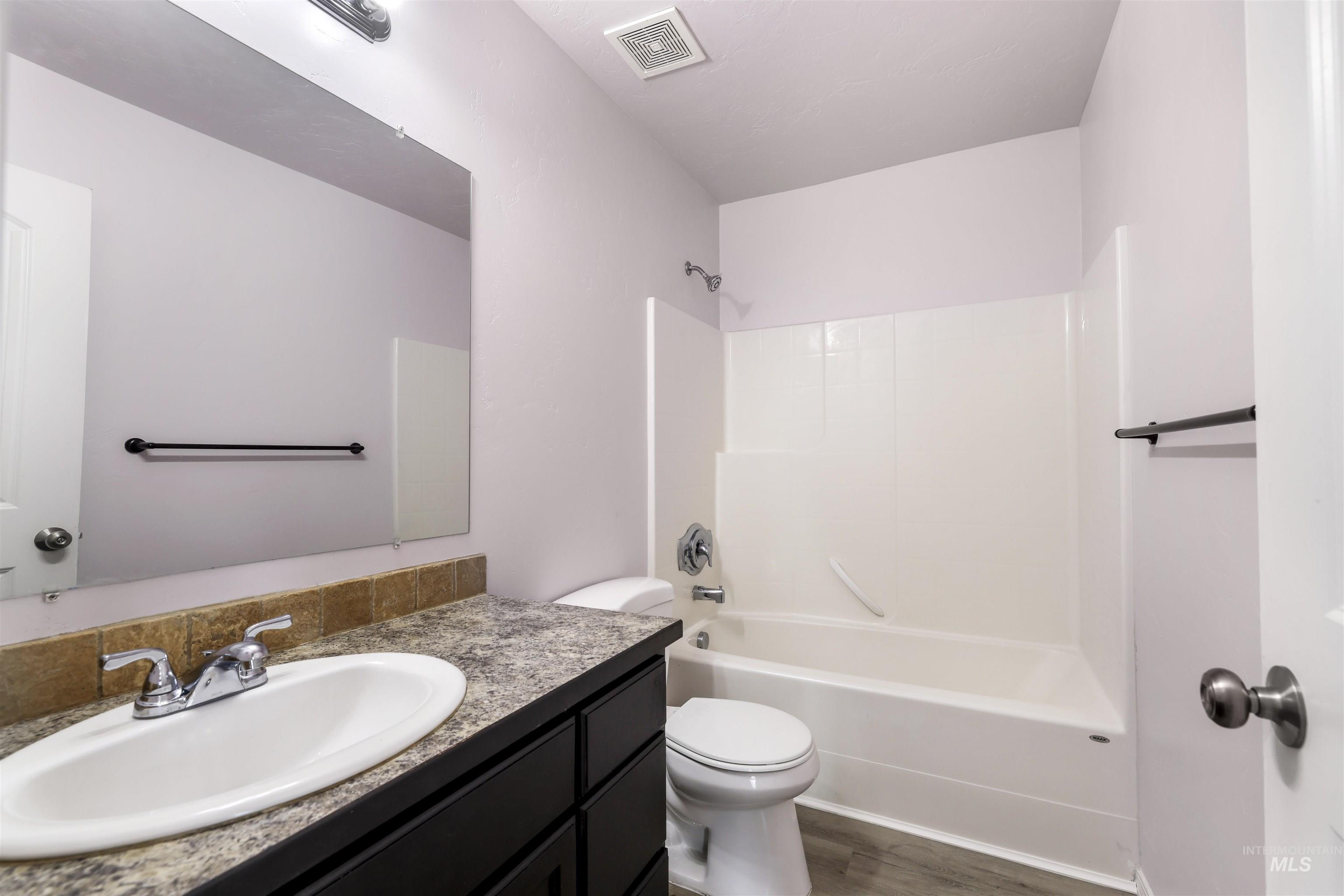 356 Watchmaker Street Twin Falls, ID 83301 - Photo 12 of 22 Full bathroom featuring vanity, tub / shower combination, and dark wood-style floors