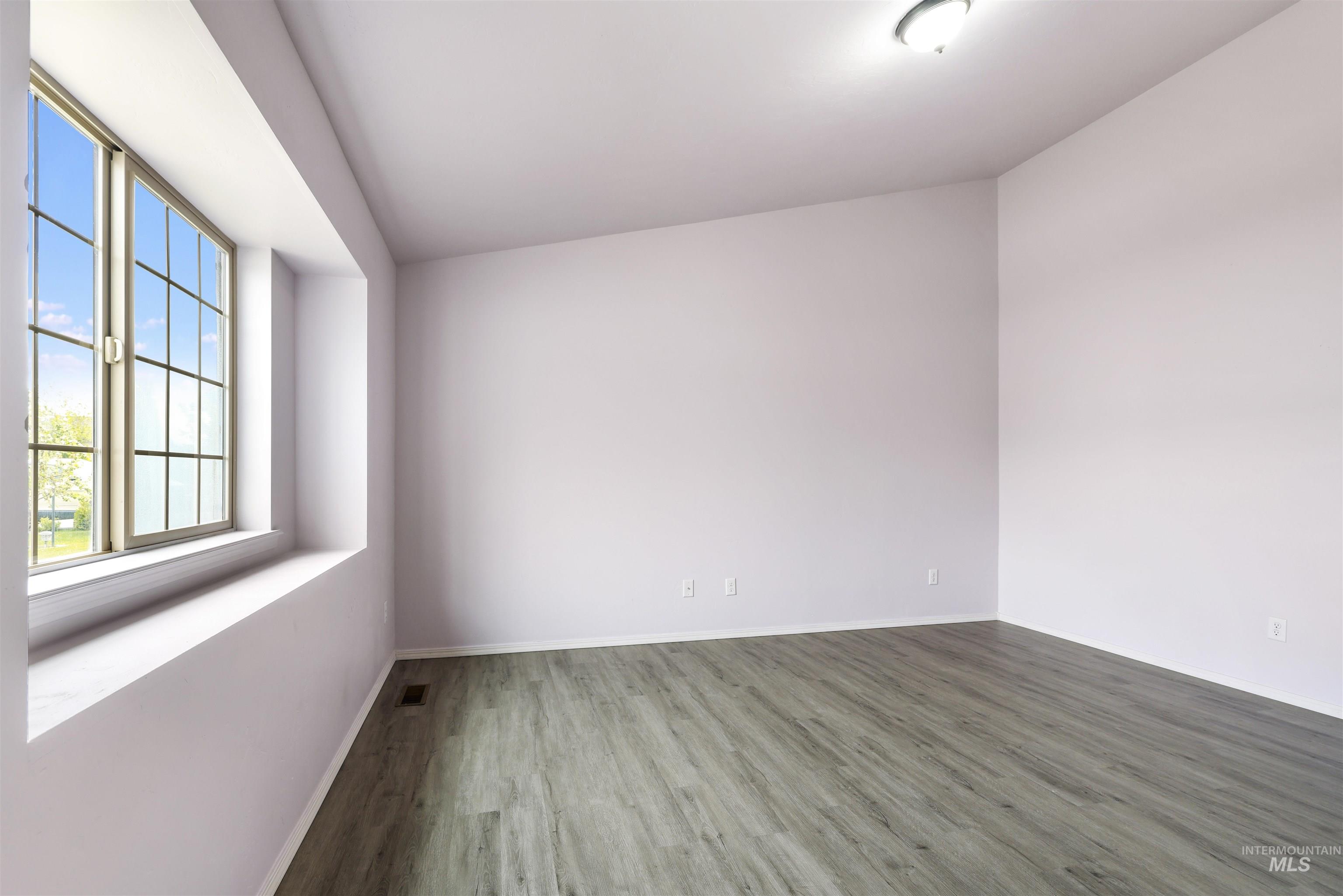 356 Watchmaker Street Twin Falls, ID 83301 - Photo 4 of 22 Unfurnished room with wood finished floors and baseboards