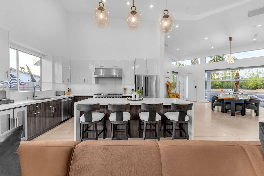 2100 East Sahara Road Palm Springs, CA 92262 - Photo 105 of 117 a large kitchen with lots of counter space dining table and chairs