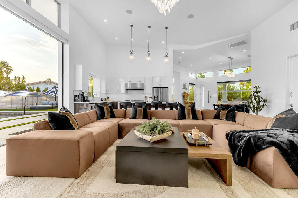 2100 East Sahara Road Palm Springs, CA 92262 - Photo 114 of 117 a living room with furniture wooden floor kitchen view and a large window