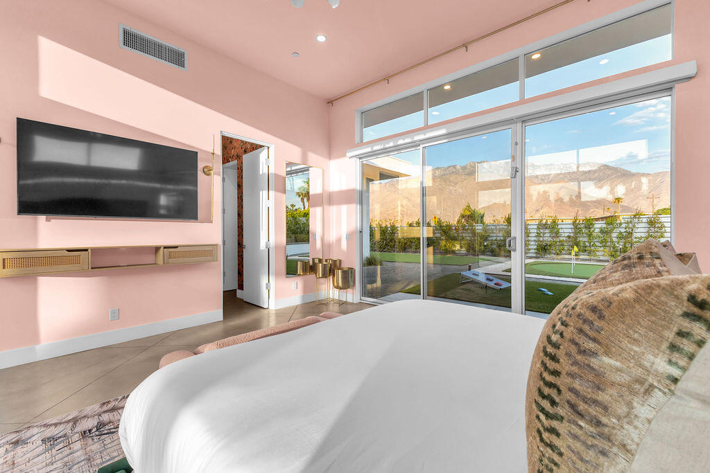 2100 East Sahara Road Palm Springs, CA 92262 - Photo 13 of 117 a living room with hardwood floor and a flat screen tv