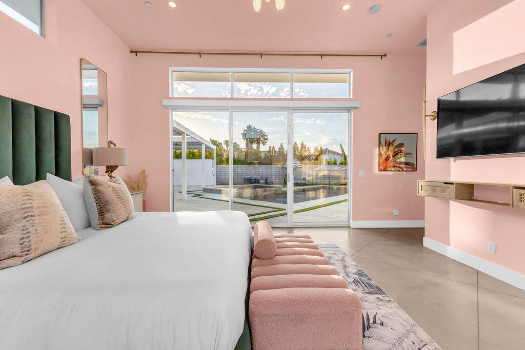 2100 East Sahara Road Palm Springs, CA 92262 - Photo 14 of 117 a bedroom with a bed and a flat screen tv