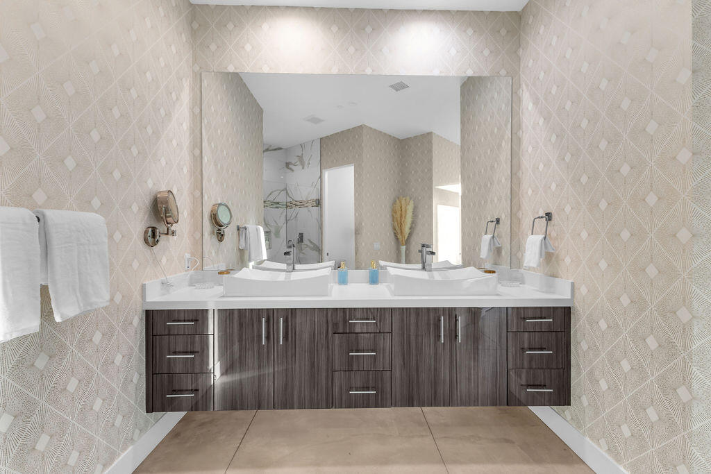 2100 East Sahara Road Palm Springs, CA 92262 - Photo 26 of 117 a view of a double sink and a mirror