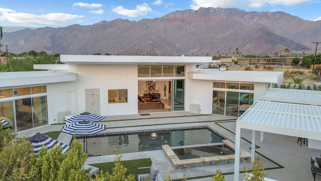 2100 East Sahara Road Palm Springs, CA 92262 - Photo 3 of 117 a view of a patio with a table and chairs