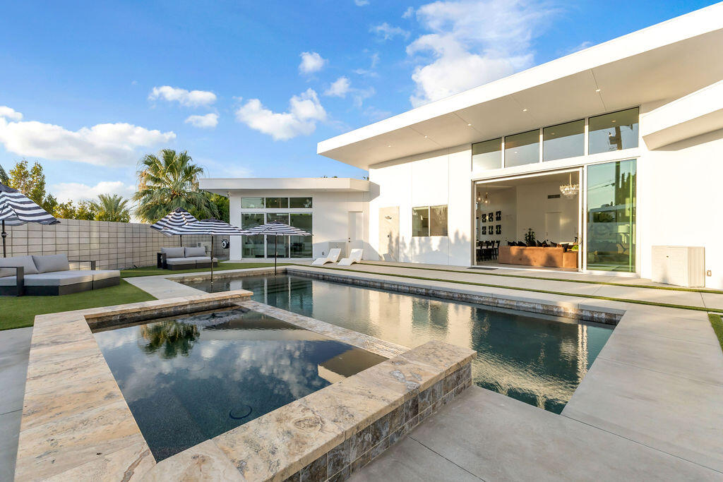 2100 East Sahara Road Palm Springs, CA 92262 - Photo 37 of 117 a view of a swimming pool with a lounge chairs