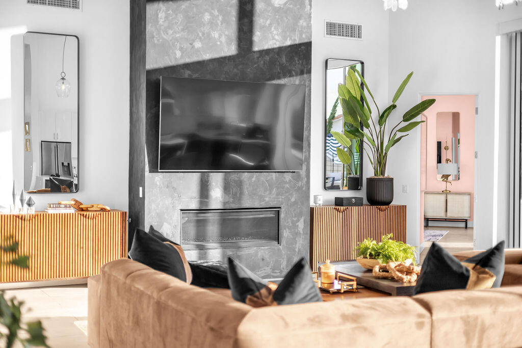 2100 East Sahara Road Palm Springs, CA 92262 - Photo 55 of 117 a living room with furniture a flat screen tv and a fireplace