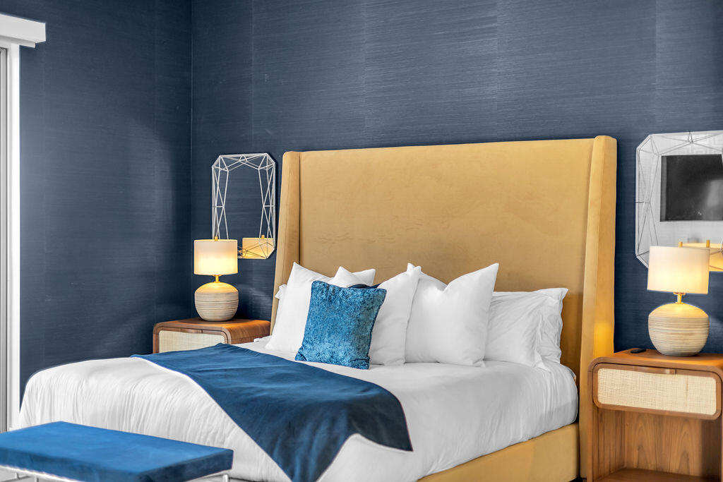 2100 East Sahara Road Palm Springs, CA 92262 - Photo 59 of 117 a bedroom with a bed and wooden floor