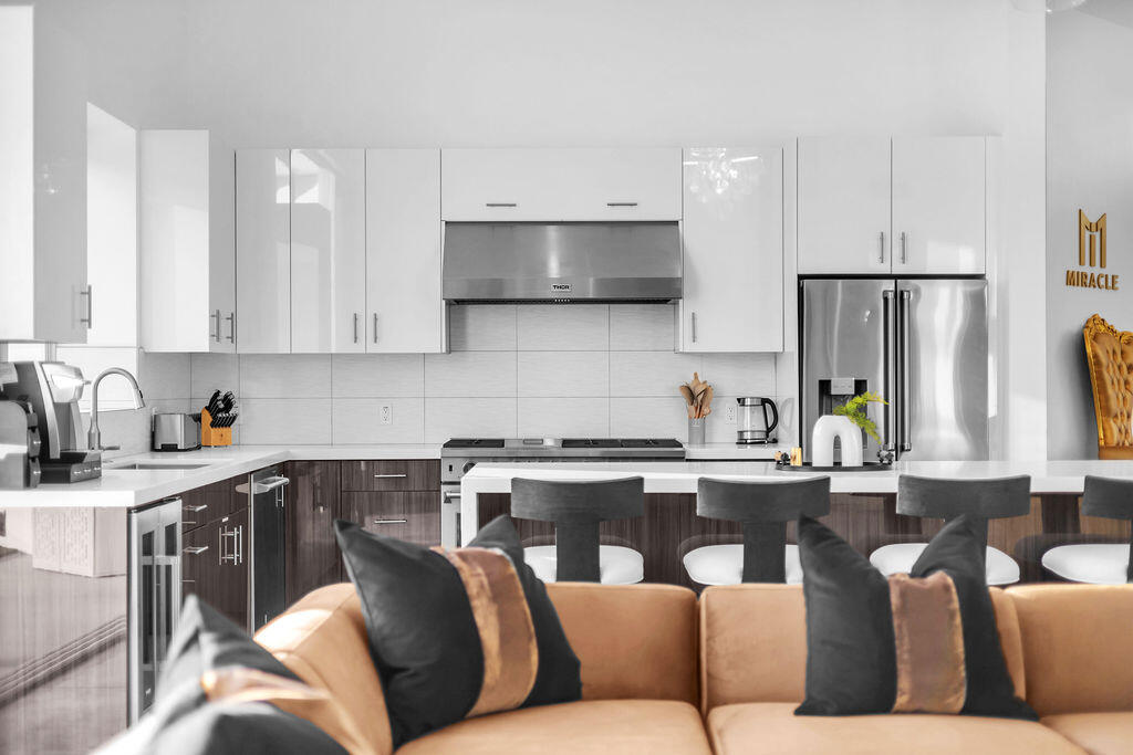 2100 East Sahara Road Palm Springs, CA 92262 - Photo 61 of 117 a living room with stainless steel appliances kitchen island granite countertop a couch and a stove top oven