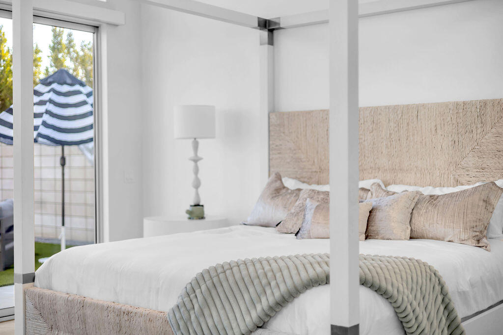 2100 East Sahara Road Palm Springs, CA 92262 - Photo 64 of 117 a bedroom with a bed and a chandelier