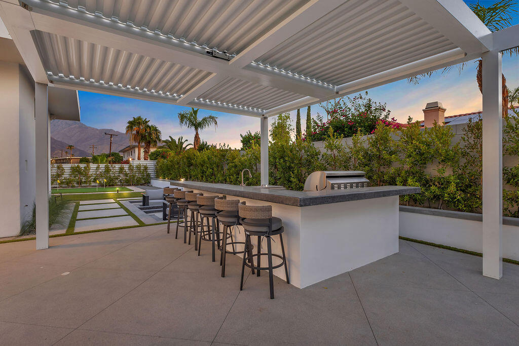 2100 East Sahara Road Palm Springs, CA 92262 - Photo 71 of 117 a patio with a table and chairs and potted plants