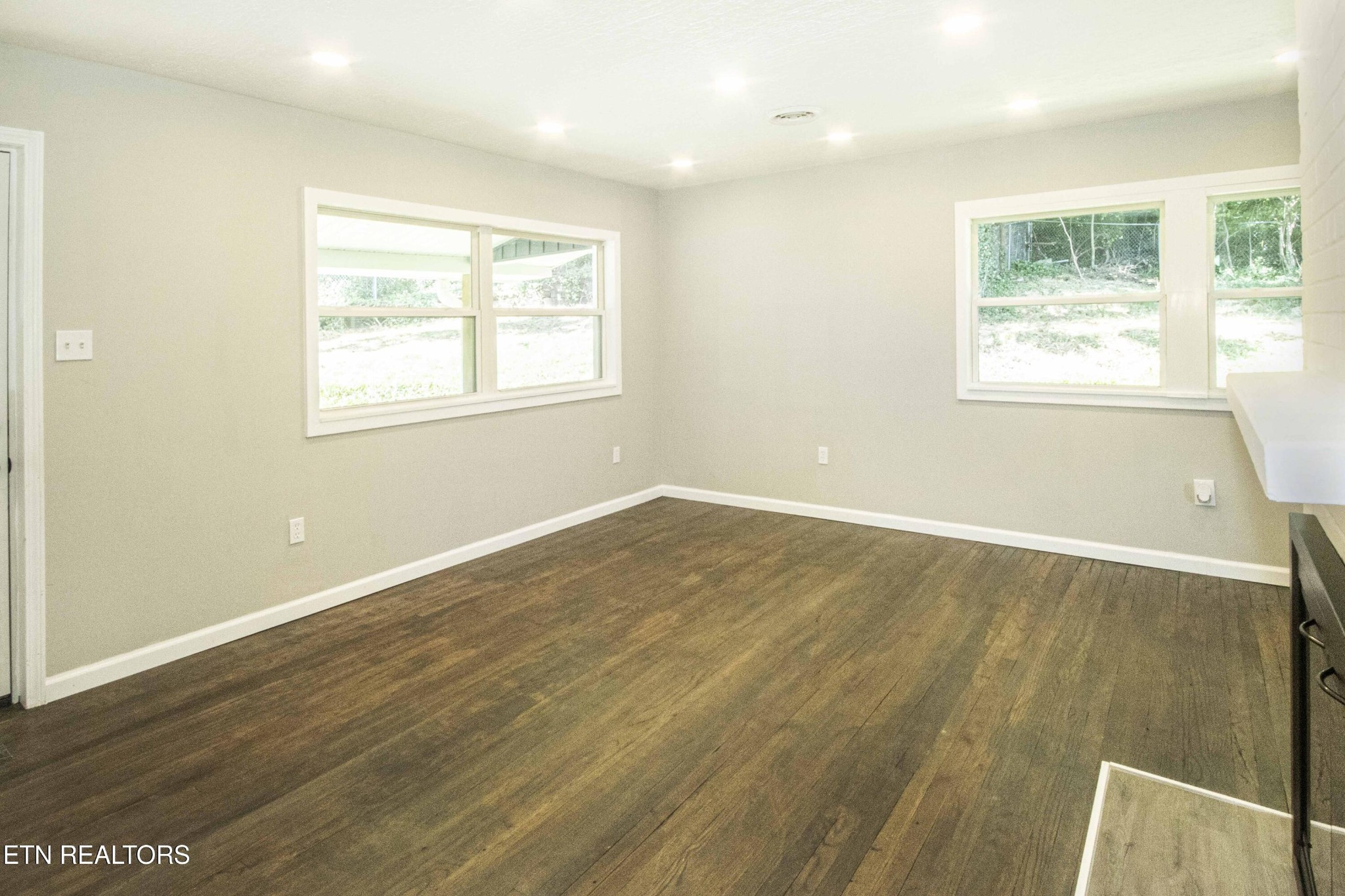 110 Delmar Circle Oak Ridge, TN 37830 - Photo 11 of 38 an empty room with wooden floor and windows