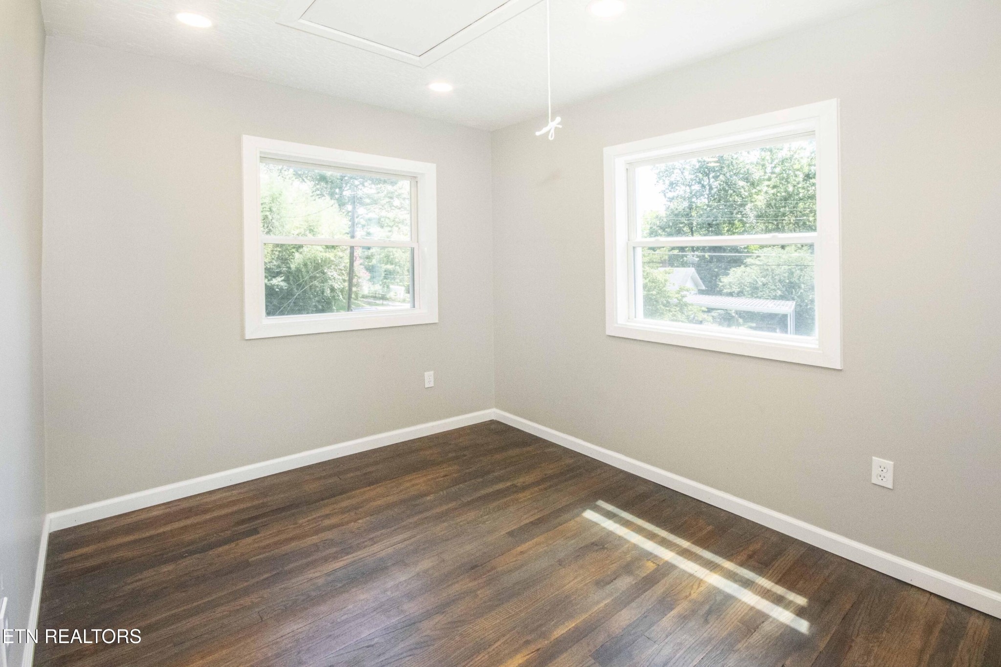 110 Delmar Circle Oak Ridge, TN 37830 - Photo 16 of 38 an empty room with wooden floor and windows