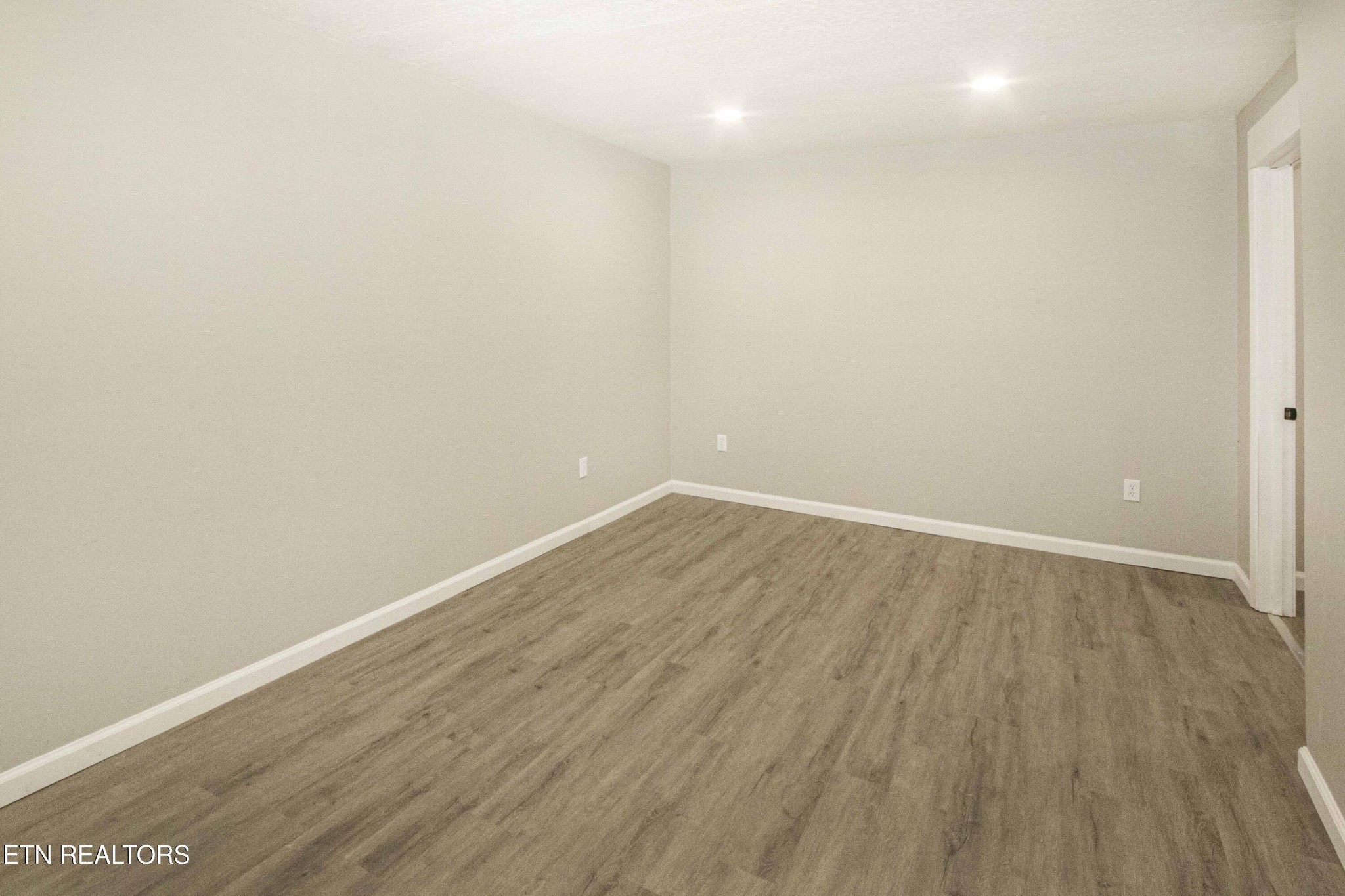 110 Delmar Circle Oak Ridge, TN 37830 - Photo 21 of 38 a view of an empty room with wooden floor and a window