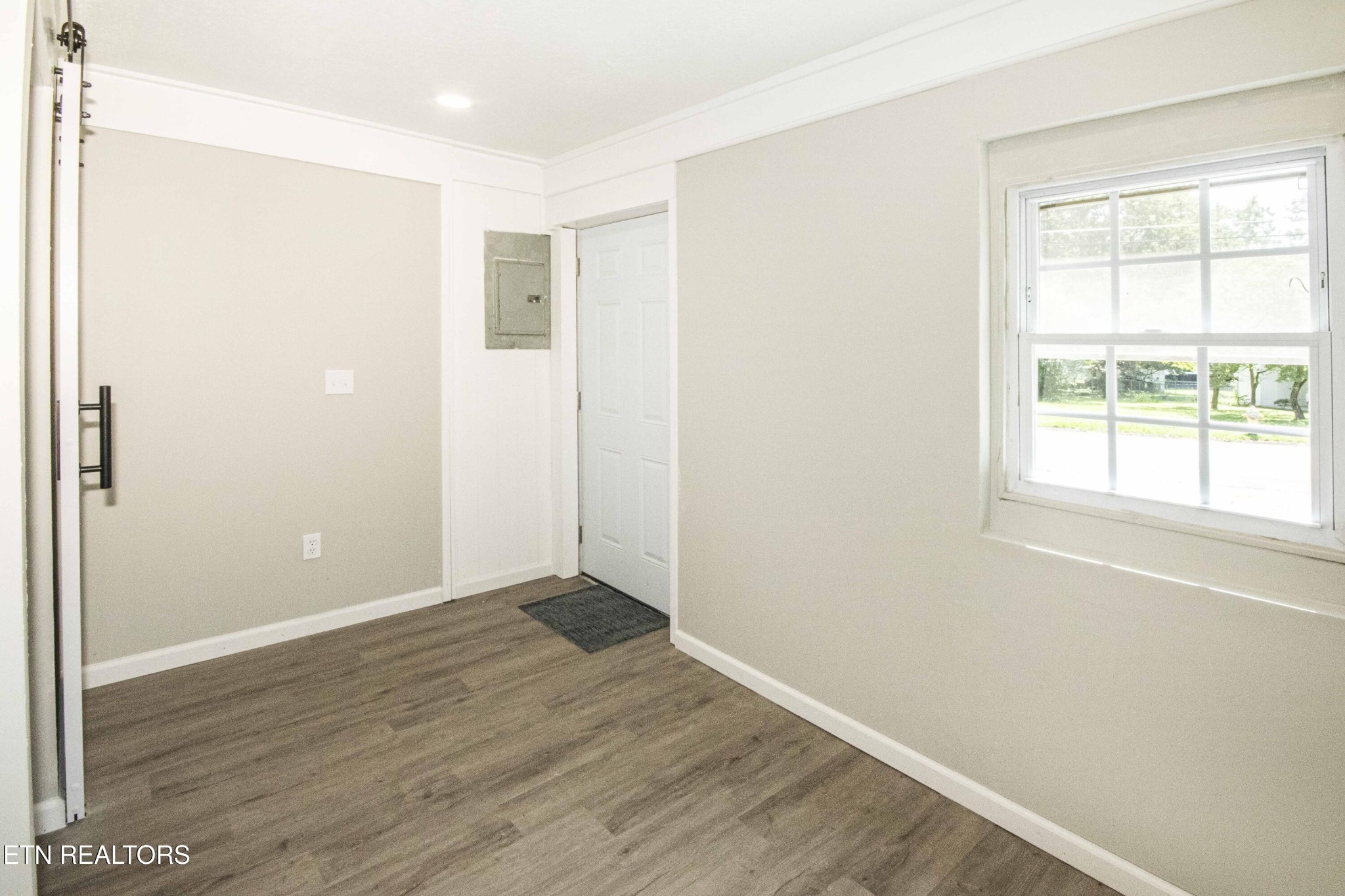 110 Delmar Circle Oak Ridge, TN 37830 - Photo 25 of 38 an empty room with wooden floor and windows