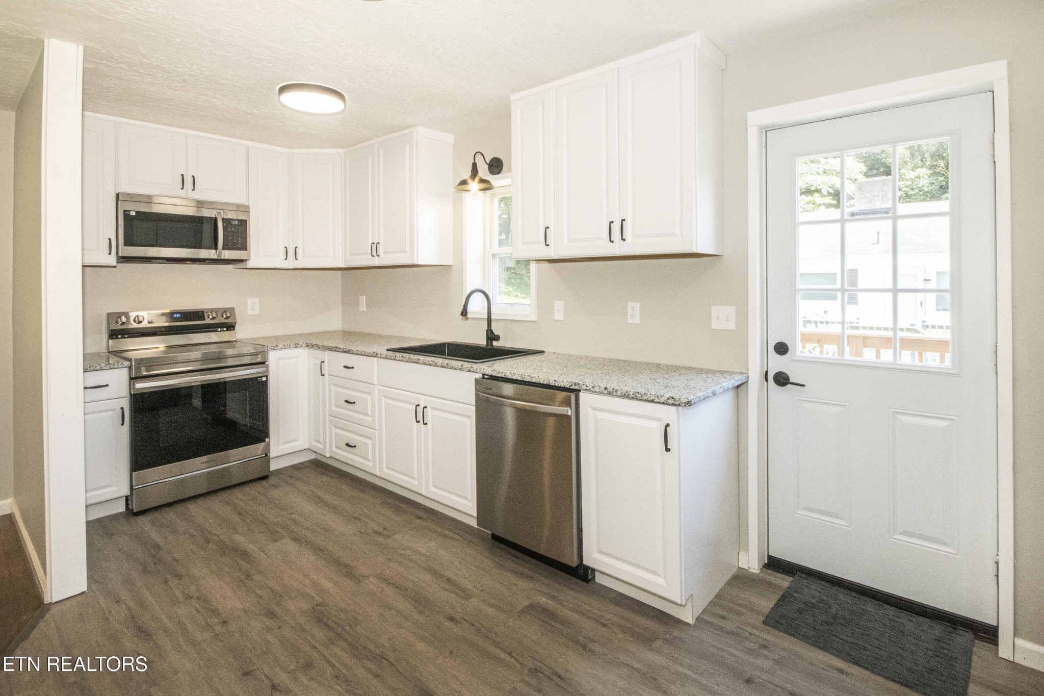 110 Delmar Circle Oak Ridge, TN 37830 - Photo 3 of 38 a white kitchen with granite countertop stainless steel appliances