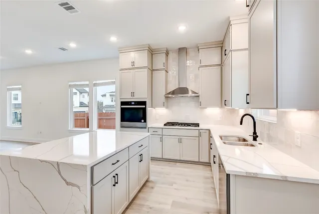 a kitchen with a stove a sink and a refrigerator