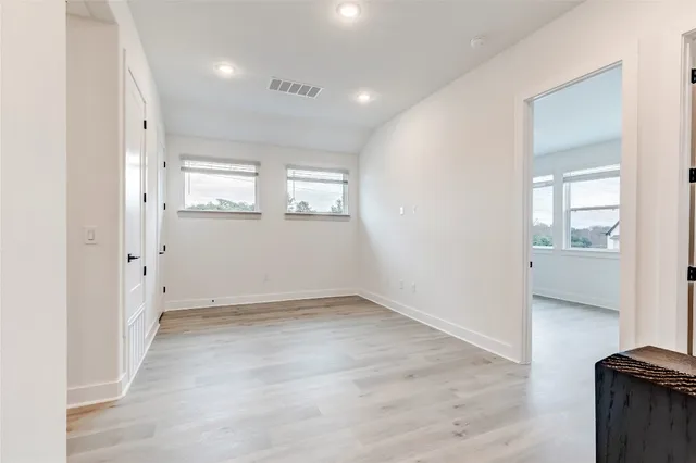 a view of walk in closet with empty racks
