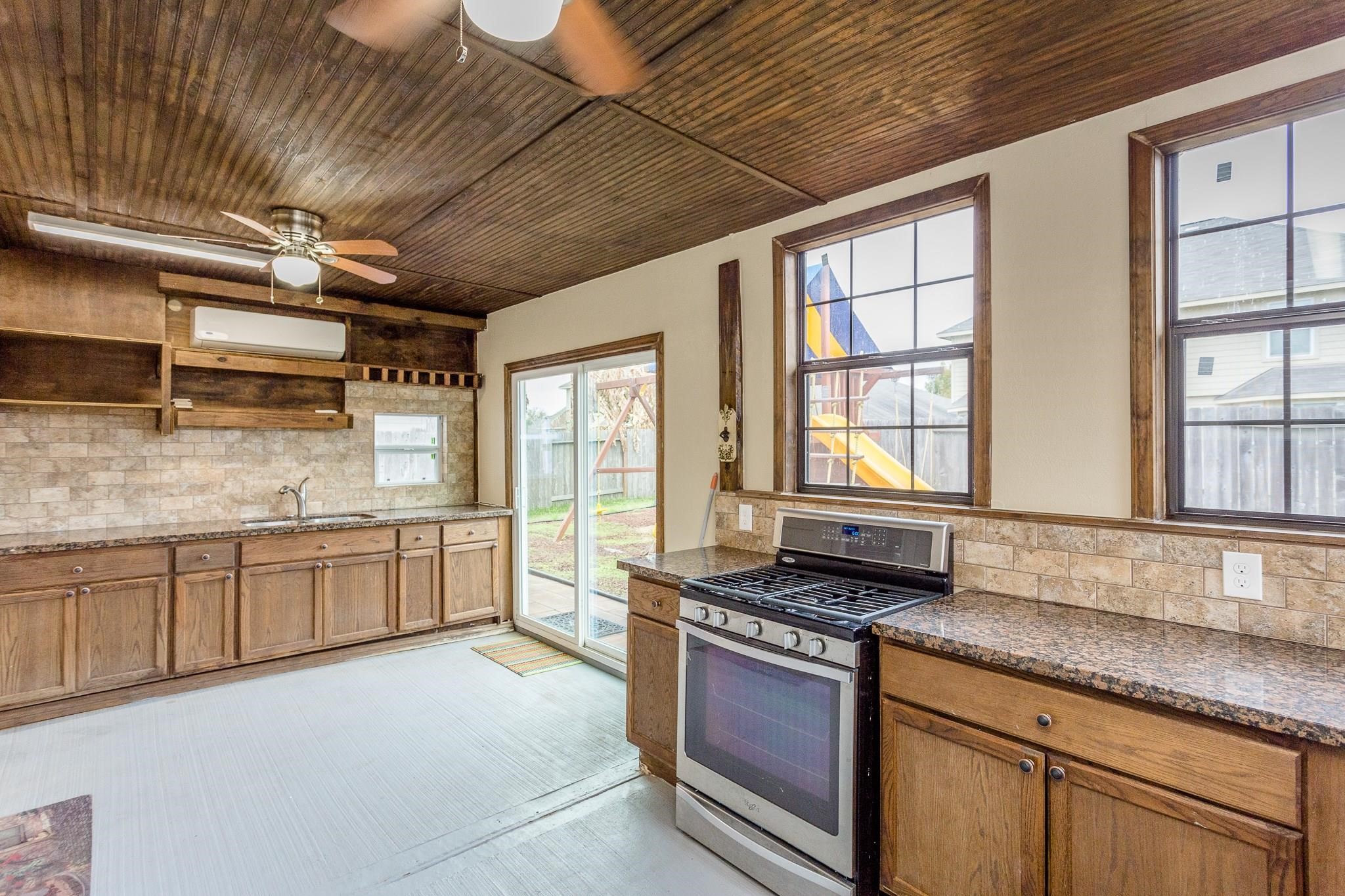 3430 Lilac Ranch Drive Katy, TX 77494 - Photo 24 of 29 a large kitchen with granite countertop a large stove a sink dishwasher and cabinets