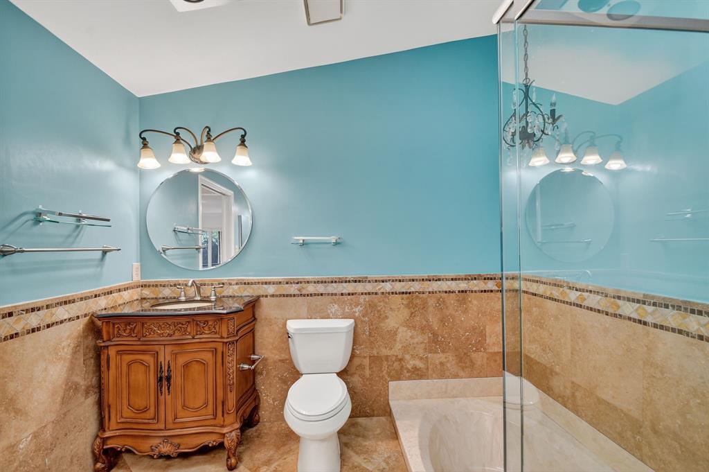 1620 Northwest 22nd Avenue Delray Beach, FL 33445 - Photo 25 of 63 a bathroom with a toilet a sink and a mirror