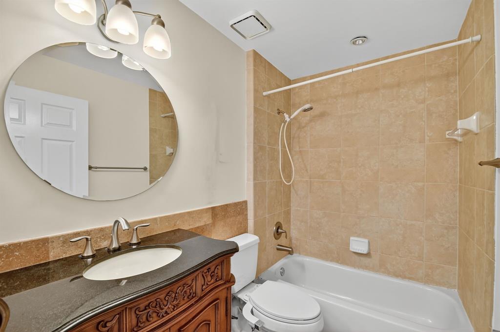 1620 Northwest 22nd Avenue Delray Beach, FL 33445 - Photo 37 of 63 a bathroom with a granite countertop sink mirror toilet and bathtub