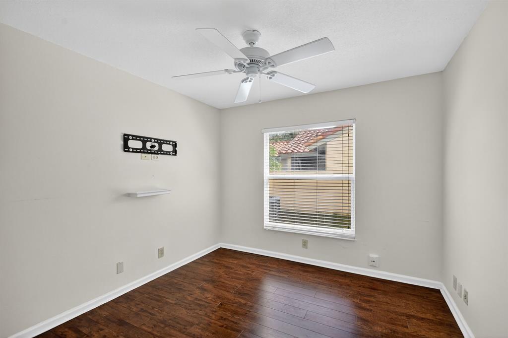 1620 Northwest 22nd Avenue Delray Beach, FL 33445 - Photo 40 of 63 a view of an empty room with wooden floor and a window