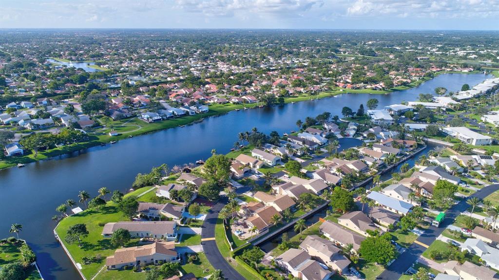 1620 Northwest 22nd Avenue Delray Beach, FL 33445 - Photo 51 of 63 an aerial view of a houses with a yard and lake view in back