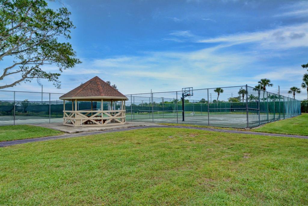 1620 Northwest 22nd Avenue Delray Beach, FL 33445 - Photo 62 of 63 a view of pool with table and chairs under an umbrella