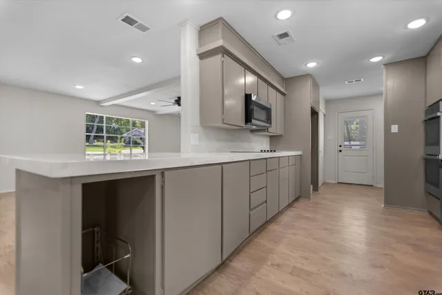a kitchen with a refrigerator and a sink