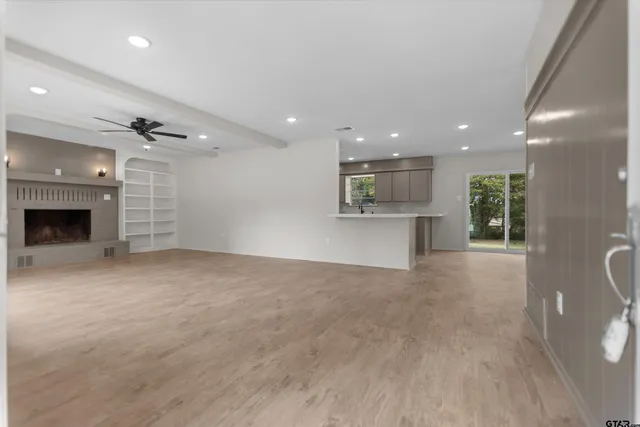 a view of a livingroom with a fireplace and cabinets