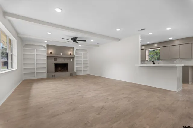 a view of an empty room with a fireplace