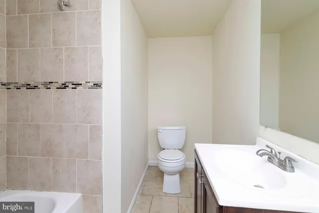 a white toilet sitting next to a bathroom sink