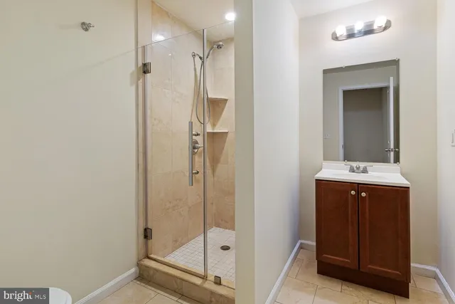 a bathroom with a shower sink and mirror