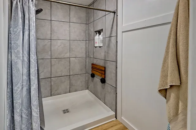 a view of a workspace with furniture and wooden floor