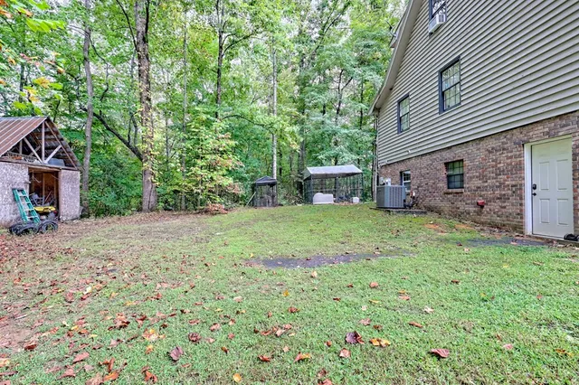 a view of a house with a yard and sitting area