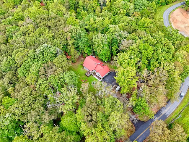 a large white kitchen with stainless steel appliances granite countertop lots of counter top space
