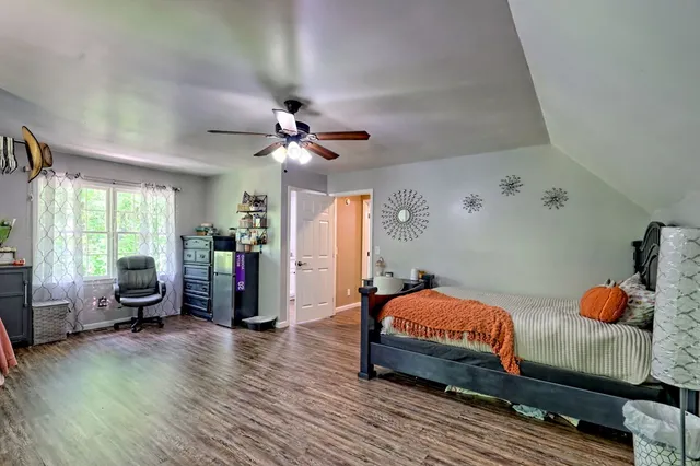 a bathroom with a granite countertop toilet and a sink