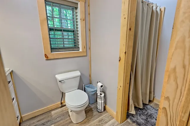 a bathroom with a toilet a sink and mirror