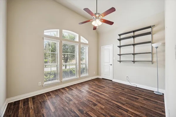 wooden floor in an empty room with a window