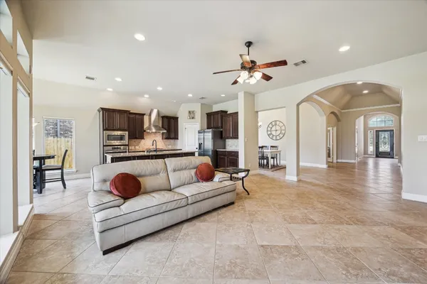 a living room with furniture and kitchen view