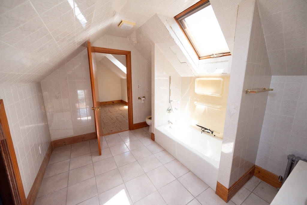 4 Winter Street Clinton, MA 01510 - Photo 18 of 33 a view of an empty room and bathroom with a tub