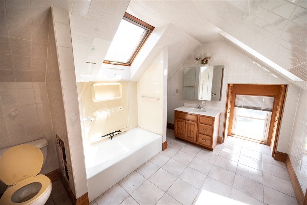 4 Winter Street Clinton, MA 01510 - Photo 19 of 33 a bathroom with a tub mirror and toilet