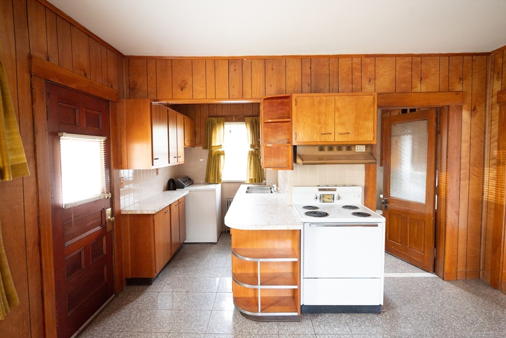 4 Winter Street Clinton, MA 01510 - Photo 20 of 33 a room with kitchen island a sink a counter and a view of living room