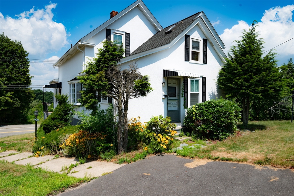 4 Winter Street Clinton, MA 01510 - Photo 2 of 33 a front view of a house with a yard and garage