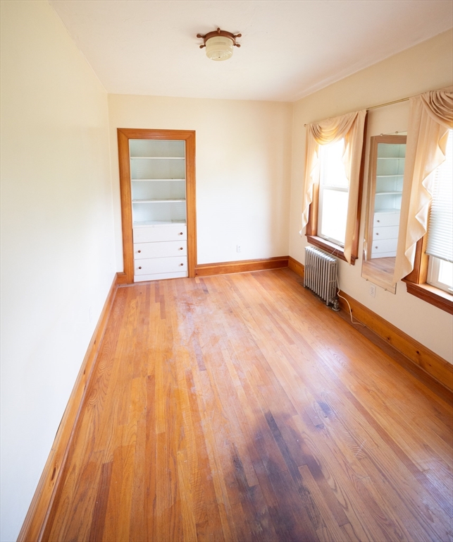 4 Winter Street Clinton, MA 01510 - Photo 22 of 33 a view of an empty room with wooden floor and a window